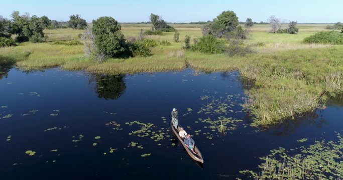 Aerial view of tourists enjoying a ride on a Mokoro - traditional canoe in the Okavango Delta
