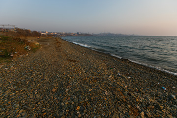 Garbage heaps on the sea beach. Pollution of the territory. Garbage dump on the beach.