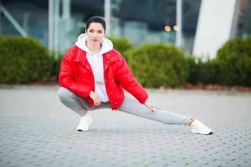 Fitness. Beautiful young woman doing exercises in the park