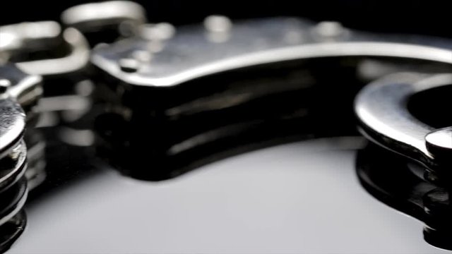 Police crime handcuffs close up. Security guard and Police officer equipment used to restrain prisoners. Safety wrist restraints.