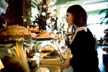 young elegant brunette woman in cafe drinking coffee, luxury interior