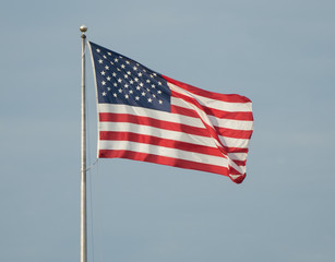 American flag flies on a sunny day
