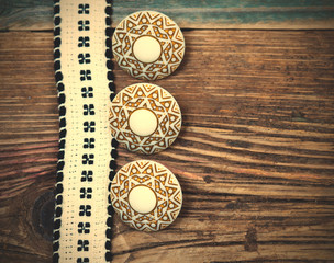 Vintage ribbon with embroidered pattern and three ancient buttons