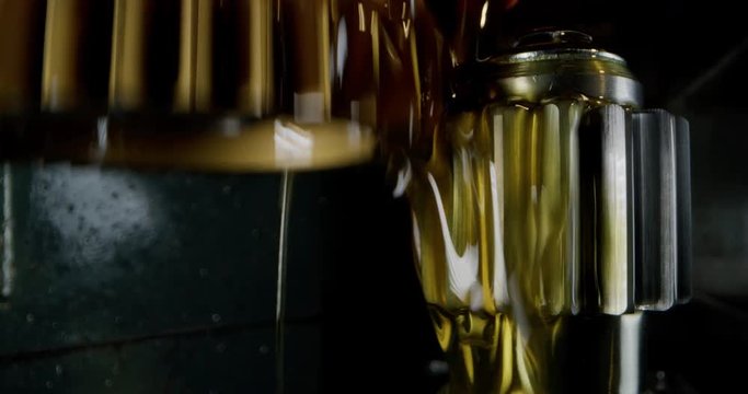 Slow motion macro of specialist is working on production of different gearing details in a workshop in industrial factory.