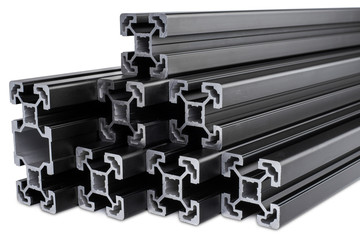 stack of black anodized aluminum extrusion bars, isolated white background. Construction metal steel factory concept.