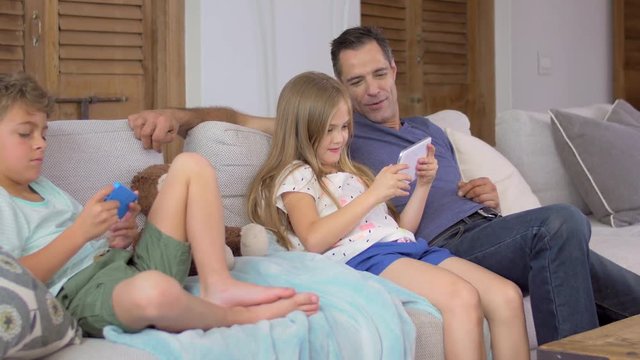 Father and kids spending time together in living room