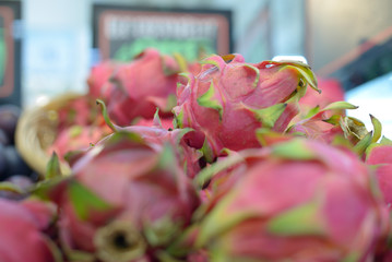 a lot of dragonfruit on the store counter