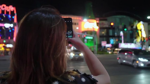 Girl looking at Las Vegas street and taking photos
