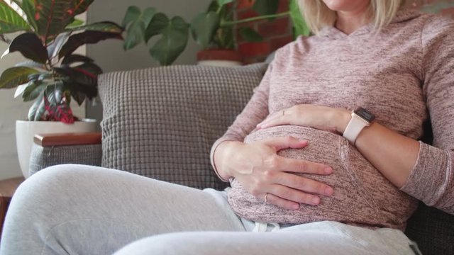 Pregnant Woman Feeling Her Belly Baby Kicking