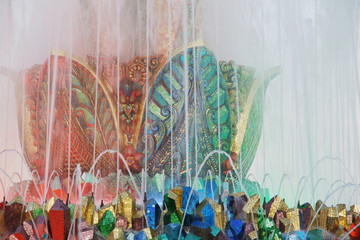 Fragment of colorful mosaic fountain in shape of  fabulous stone flower made of gems