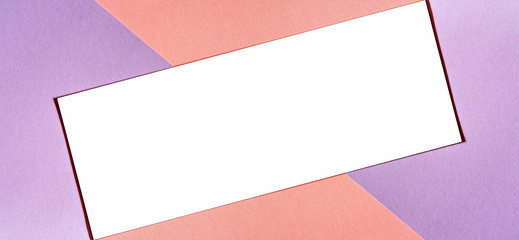 Multicolored paper background with trendy coral color of the year 2019 and a white isolated place for your text. Colorful paper with soft light trendy coral color and free isolated copy space.