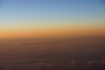 Aerial of Sunrise light over the world full of clouds