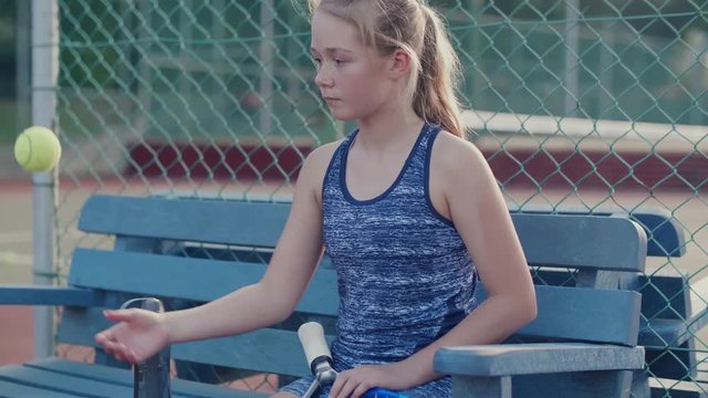 Young tennis player waiting for training to begin