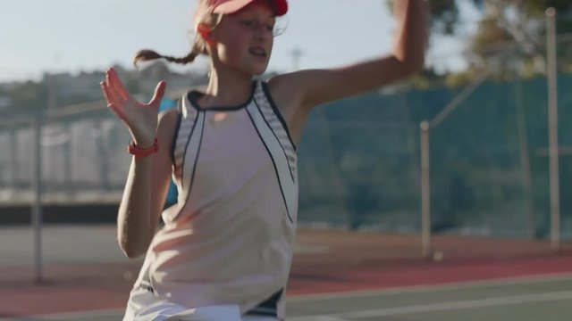 Female tennis player returning serve on court