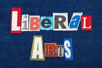 LIBERAL ARTS text word collage, colorful fabric on blue denim, humanities education, horizontal aspect
