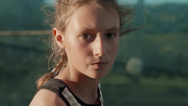 Slow motion portrait of young tennis player about to serve
