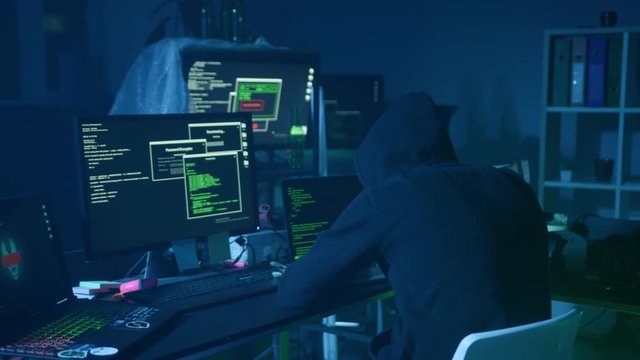 Surprised computer hacker arrested at internet crime at night. Portrait of criminal looking under flashlight at policeman.