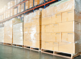 stacked of cardboard boxes on wooden pallet in warehouse.