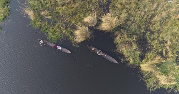 Aerial straigtdown shot of tourists enjoying a Mokoro ride in the Okavango Delta, Botswana