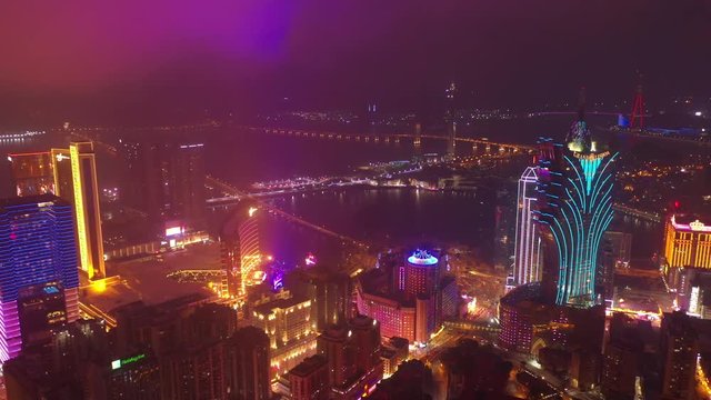 night time illumination flight over macau city famous hotel area bay aerial panorama 4k china