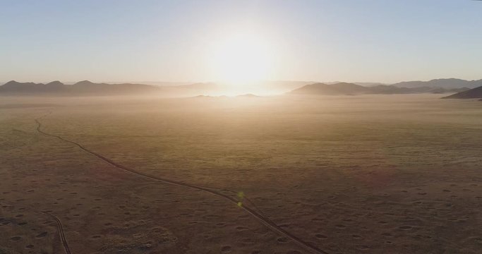4K high aerial zoom in sunset view of the Koakoland savannah region of the Namib desert showing the famous fairy circles, Namibia