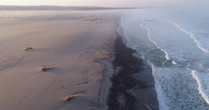 4K aerial fly over view of tourists camping on the shoreline of the Atlantic Ocean,Skeleton Coast,Namibia