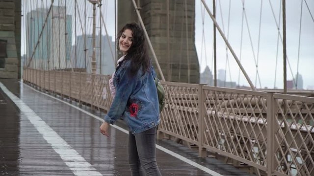 Young woman walking at Brooklyn bridge in New York