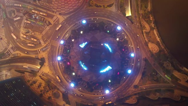night time illuminated macau city traffic circle bay aerial topdown panorama 4k china