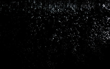Naklejka na ściany i meble air bubbles water splash on black background.