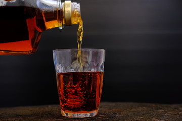 close up whisky on old wood background