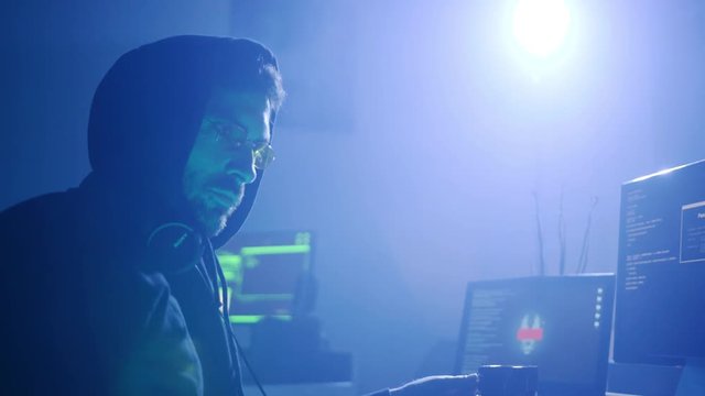 Profile of confident professional hacker working with identity writing data codes and drinking coffee in the office.