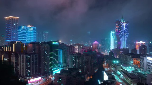 night time illumination flight over macau city famous hotel area aerial panorama 4k china