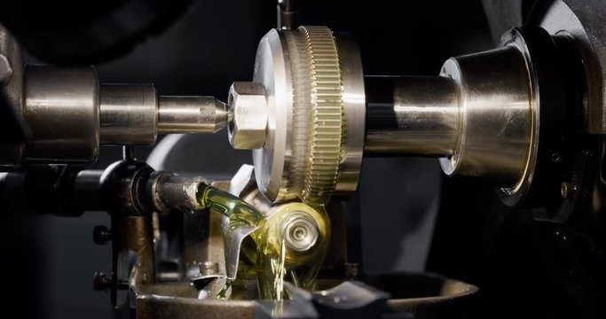 Slow motion macro of specialist is working on production of different gearing details in a workshop in industrial factory.