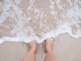Selfie woman feet on summer beach background.