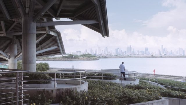 PANAMÁ CITY, PANAMÁ - CIRCA SEPTEMBER 2015: Man contemplating skyscrapers of the coastline from panoramic view at the Biomuseo Panama