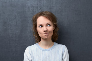 Portrait of puzzled girl thinking and making choice