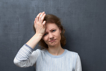 Portrait of upset girl suffering from migraine