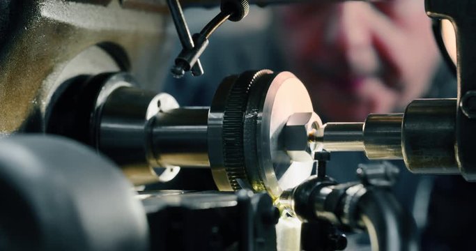 Slow motion macro of specialist is working on production of different gearing details in a workshop in industrial factory.