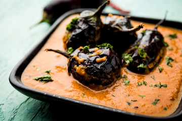 Baingan masala / Eggplant / brinjal curry served in bowl or pan, selective focus