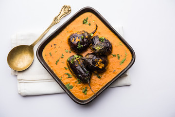 Baingan masala / Eggplant / brinjal curry served in bowl or pan, selective focus
