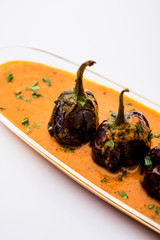 Baingan masala / Eggplant / brinjal curry served in bowl or pan, selective focus