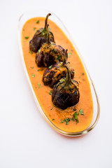 Baingan masala / Eggplant / brinjal curry served in bowl or pan, selective focus