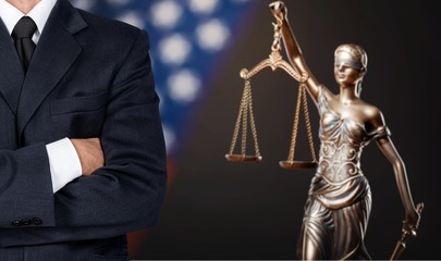 Lawyer standing with crossed arms, Scales of Justice on the background