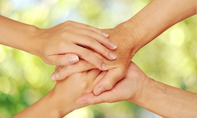 Hands of the old man and a young woman. close up.