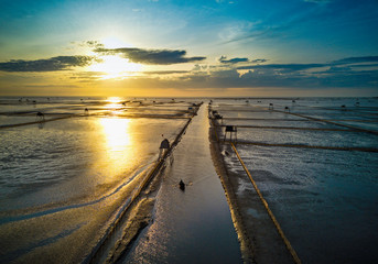 Obraz premium Sunrise over clam farms on the beach. Location: Thaibinh, Vietnam