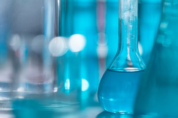 Researchers are using glassware and blue solutions in laboratories, research on cosmetics and energy.