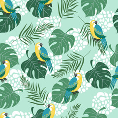 Modèle sans couture dessiné à la main avec des oiseaux tropicaux et des feuilles sur fond bleu. Plate illustration vectorielle de perroquets.