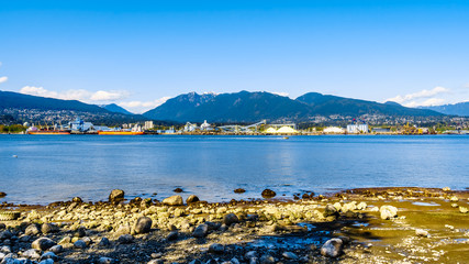 View of the North Shore of the Vancouver Harbor with Grouse Mountain in the background. Viewed from the Stanley Park Seawall pathway