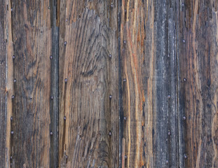 Naklejka premium Weathered, aged boards nailed to a wall.