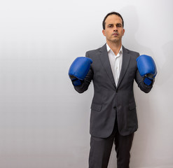 man standing in formal clothes and boxing glove doing fight positions (photo 2/9)